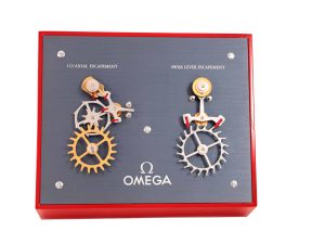 Lot #AN3835A – Omega Moving Display Co-Axial Escapement VS Swiss Lever Escapement Machine Watches Omega