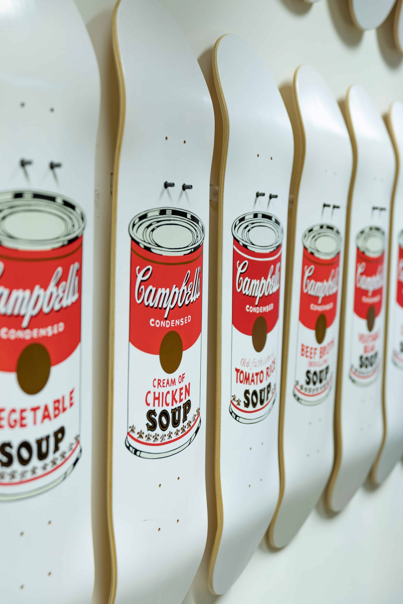 Multi-deck artist skateboard set displayed as wall art